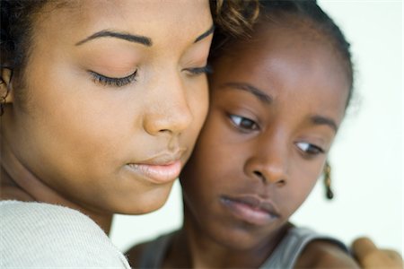sad african children - Mother and daughter cheek to cheek, both looking down, close-up Stock Photo - Premium Royalty-Free, Code: 632-01785133