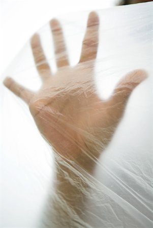 Hand inside plastic bag, cropped view Stock Photo - Premium Royalty-Free, Code: 632-01785232