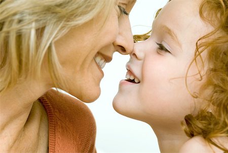 Mother and daughter touching noses and smiling at each other, cropped view Stock Photo - Premium Royalty-Free, Code: 632-01785330