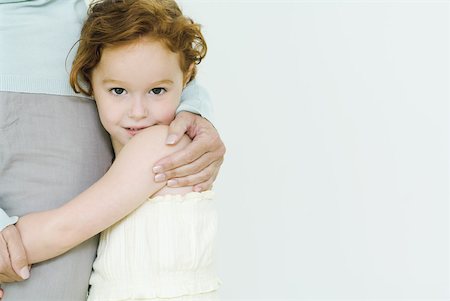 simsearch:632-01193783,k - Little girl hugging mother's leg, looking at camera Stock Photo - Premium Royalty-Free, Code: 632-01785391