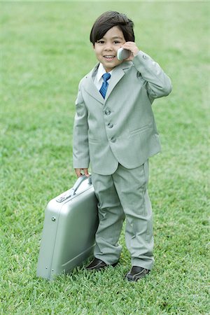 simsearch:695-05768235,k - Little boy dressed as businessman, using cell phone, full length Stock Photo - Premium Royalty-Free, Code: 632-01785437