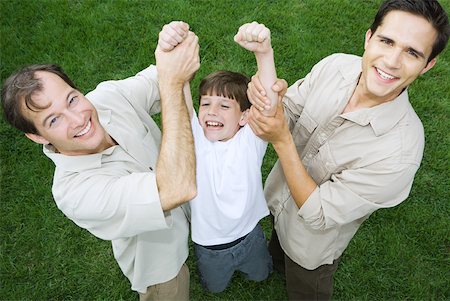 roughhousing - Two men holding up little boy by his arms, all smiling, high angle view Stock Photo - Premium Royalty-Free, Code: 632-01828628