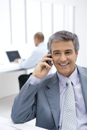 simsearch:695-03376228,k - Businessman using cell phone in office Stock Photo - Premium Royalty-Free, Code: 632-02008132