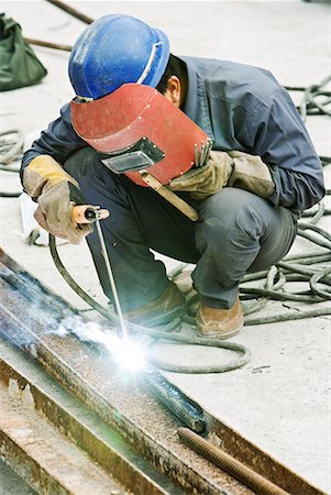 Worker welding metal rod at construction site, close-up Stock Photo - Premium Royalty-Free, Code: 632-02038728