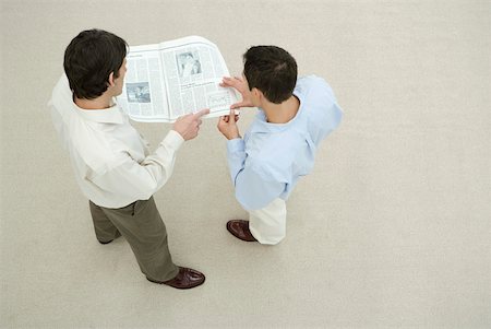 simsearch:632-03027302,k - Two men looking at newspaper together, overhead view Stock Photo - Premium Royalty-Free, Code: 632-02128085
