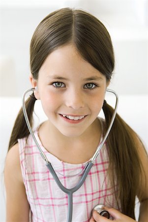 simsearch:695-05768235,k - Girl listening to her own heart through stethoscope Stock Photo - Premium Royalty-Free, Code: 632-02227653