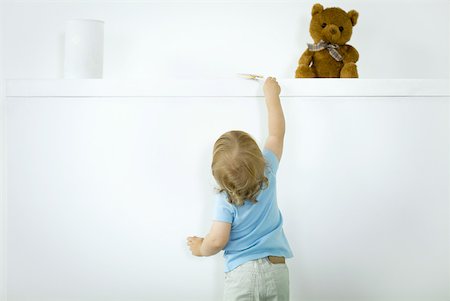 simsearch:632-03027302,k - Toddler reaching for lollipop on high shelf, rear view Stock Photo - Premium Royalty-Free, Code: 632-02282507