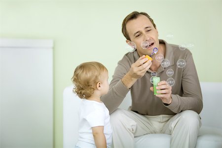 simsearch:632-05604245,k - Father and toddler blowing bubbles together Stock Photo - Premium Royalty-Free, Code: 632-02282511