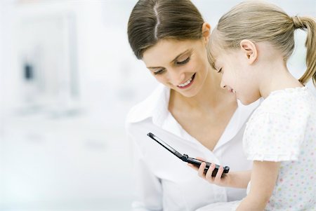 simsearch:632-01193783,k - Mother and young daughter looking at cell phone together Stock Photo - Premium Royalty-Free, Code: 632-02282933