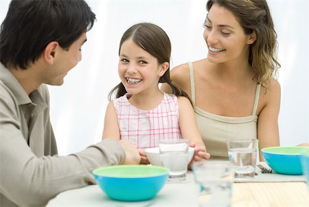 family indoors summer - Family sitting together at the table, smiling at each other Stock Photo - Premium Royalty-Free, Code: 632-02344574