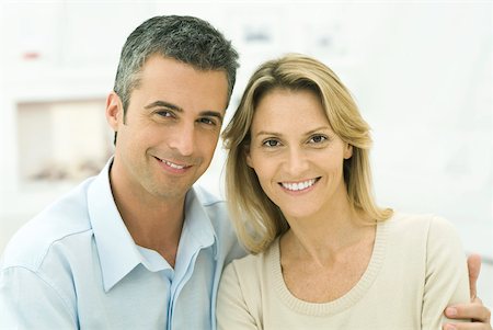 Couple smiling at camera, man's arm around woman's shoulder, portrait Stock Photo - Premium Royalty-Free, Code: 632-02344997