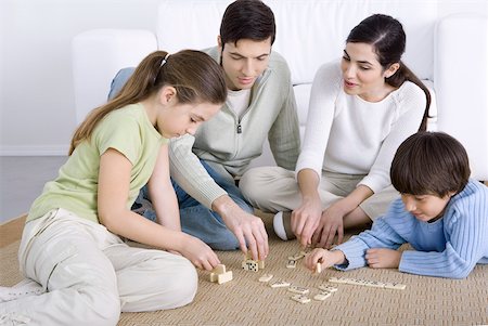 simsearch:695-03378605,k - Parents and two children seated on floor, playing dominoes together Stock Photo - Premium Royalty-Free, Code: 632-02345185