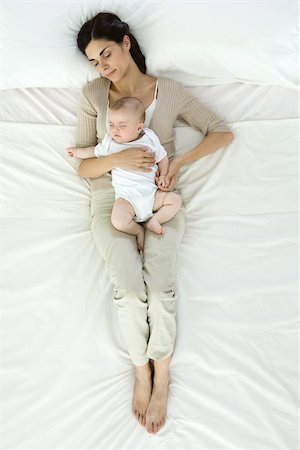 proximity - Mother and baby napping together on bed, overhead view Stock Photo - Premium Royalty-Free, Code: 632-02416235