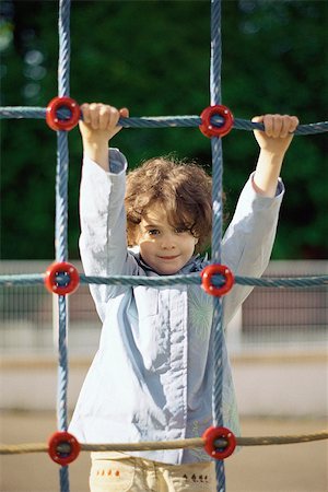 Little girl on rope climbing net, portrait Stock Photo - Premium Royalty-Free, Code: 632-02690106