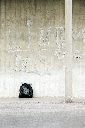 Bag of garbage leaning against wall Stock Photo - Premium Royalty-Free, Code: 632-02690379