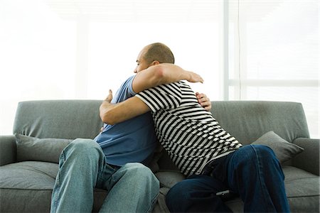 picture of gay men embracing - Two men embracing on sofa Stock Photo - Premium Royalty-Free, Code: 632-02744847