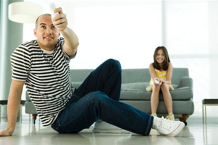 entertainment and game - Father and daughter playing video game with wireless controllers Stock Photo - Premium Royalty-Free, Code: 632-02744860