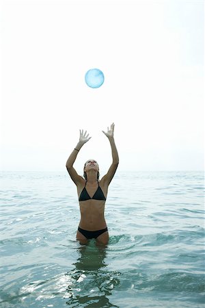 Teen girl standing in sea, catching ball Stock Photo - Premium Royalty-Free, Code: 632-02745220