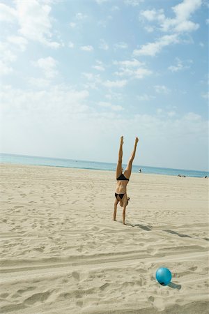 simsearch:633-01714467,k - Teen girl doing handstand on beach Stock Photo - Premium Royalty-Free, Code: 632-02745238