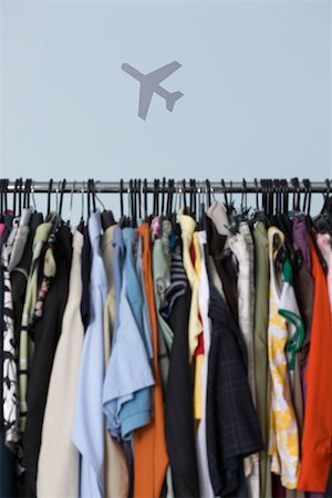 Rack of clothing, airplane in background Stock Photo - Premium Royalty-Free, Code: 632-02745321