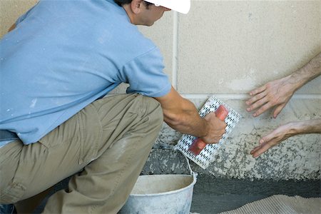 Mason receving guidance on proper masonry technique Stock Photo - Premium Royalty-Free, Code: 632-02885335