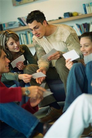 stage show - Friends looking at each other's photo collection Stock Photo - Premium Royalty-Free, Code: 632-03026791