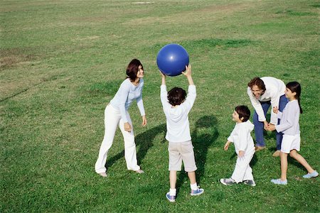 simsearch:400-05309800,k - Family playing with ball in grassy field Stock Photo - Premium Royalty-Free, Code: 632-03026985