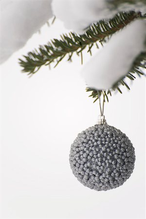 simsearch:614-06336098,k - Silver Christmas ornament hanging from snow-covered evergreen branch Stock Photo - Premium Royalty-Free, Code: 632-03027622