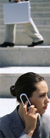 simsearch:632-03083042,k - Businesswoman using cell phone, looking away Stock Photo - Premium Royalty-Free, Code: 632-03083033