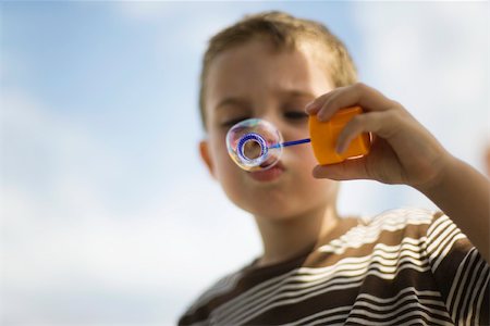 simsearch:632-05604245,k - Little boy blowing bubble with bubble wand Stock Photo - Premium Royalty-Free, Code: 632-03083462
