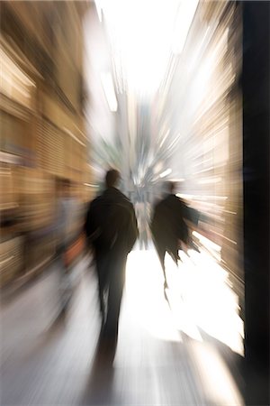 panning (camera technique) - Pedestrians walking, rear view, blurred Stock Photo - Premium Royalty-Free, Code: 632-03083482