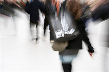 panning - Shopper carrying shopping bag, blurred Stock Photo - Premium Royalty-Free, Code: 632-03083497