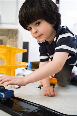 playing toy car - Little boy playing with toy cars, close-up Stock Photo - Premium Royalty-Free, Code: 632-03083575