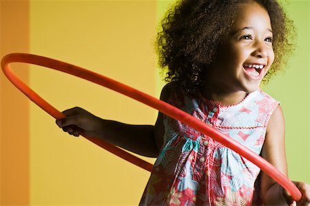 Girl playing with plastic hoop Stock Photo - Premium Royalty-Free, Code: 632-03083617