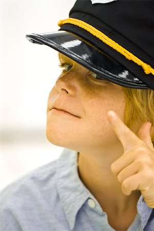 simsearch:614-06896861,k - Boy wearing police officer's hat pointing at camera Stock Photo - Premium Royalty-Free, Code: 632-03083640