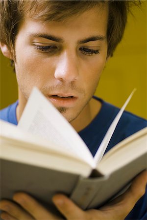 simsearch:632-03083700,k - Young man reading book, close-up Stock Photo - Premium Royalty-Free, Code: 632-03083641