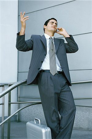 simsearch:632-03083042,k - Businessman leaning against railing and using cell phone, making frustrated gesture with hand Stock Photo - Premium Royalty-Free, Code: 632-03083717