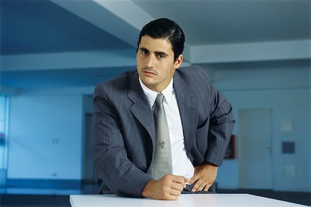 simsearch:632-03083042,k - Businessman staring intently at camera with clenched fist on table Stock Photo - Premium Royalty-Free, Code: 632-03083742