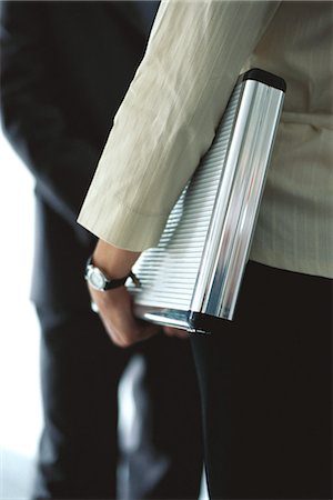 simsearch:632-03083042,k - Businesswoman carrying briefcase under arm in conversation with colleague, mid section Stock Photo - Premium Royalty-Free, Code: 632-03083773