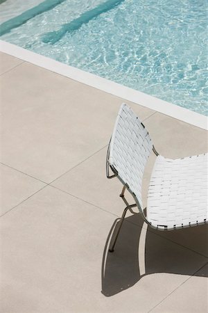 refraction - Chair at edge of shallow pool Stock Photo - Premium Royalty-Free, Code: 632-03193615