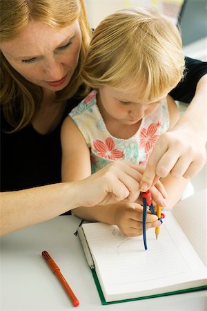 school mother and child - Woman helping little girl draw with compass Stock Photo - Premium Royalty-Free, Code: 632-03193672