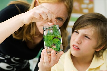 preteen touch - Elementary teacher showing student plant specimen in jar Stock Photo - Premium Royalty-Free, Code: 632-03193692