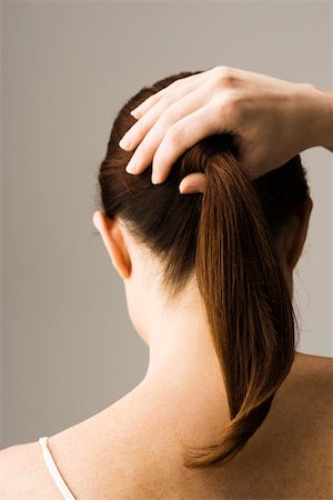 Woman styling hair, rear view Stock Photo - Premium Royalty-Free, Code: 632-03403357