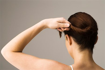 Woman styling hair, rear view Stock Photo - Premium Royalty-Free, Code: 632-03403358