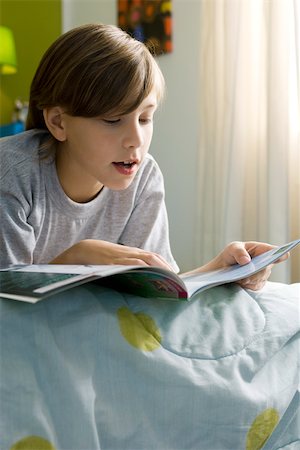 simsearch:632-03424261,k - Boy lying on bed reading book Stock Photo - Premium Royalty-Free, Code: 632-03424227