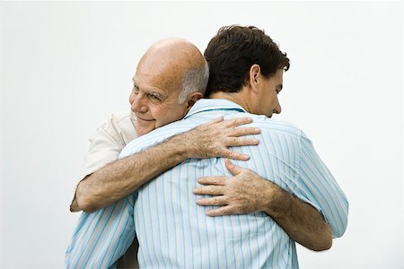 seniors back interior - Senior man embracing adult son Stock Photo - Premium Royalty-Free, Code: 632-03424370