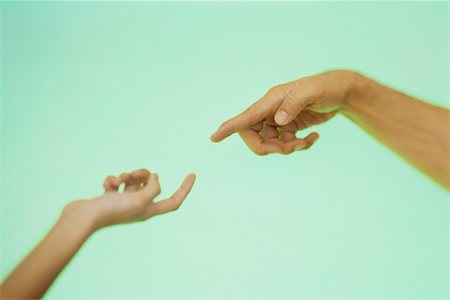 simsearch:632-05816631,k - Two hands reaching toward each other with index fingers extended Stock Photo - Premium Royalty-Free, Code: 632-03424699