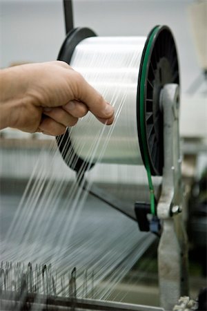 Weaving mill, machinist manually checking thread tension Stock Photo - Premium Royalty-Free, Code: 632-03500473