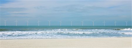 Wind turbines along horizon in ocean Stock Photo - Premium Royalty-Free, Code: 632-03500606