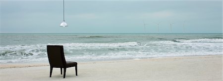 simsearch:632-03500607,k - Lamp hanging over chair on beach, wind turbines visible along horizon Stock Photo - Premium Royalty-Free, Code: 632-03500610
